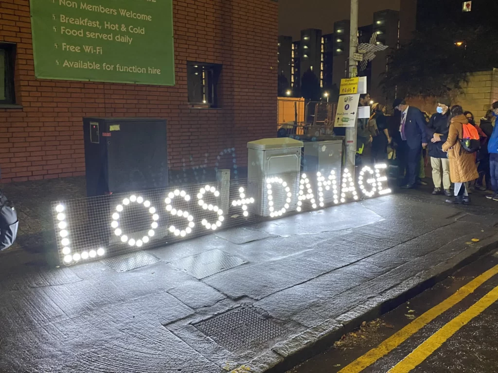 the Loss and Damage Banner on its way to the Quakers Vigil 